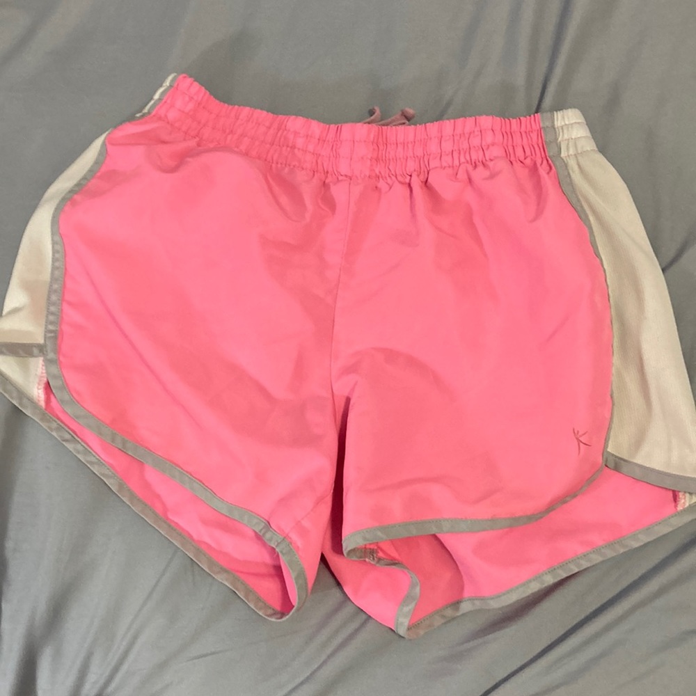 pink shorts with white stripes on side